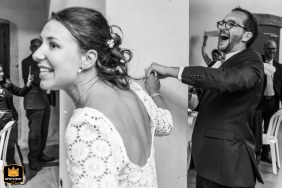 Excitement fills the grand entrance at Château de Cypierre in Volesvres, Bourgogne, France, as the bride and groom are warmly welcomed into the reception room.